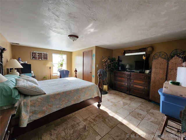 bedroom featuring a textured ceiling