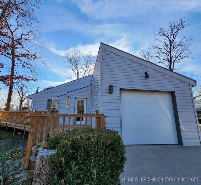 view of front of property with a garage and a deck