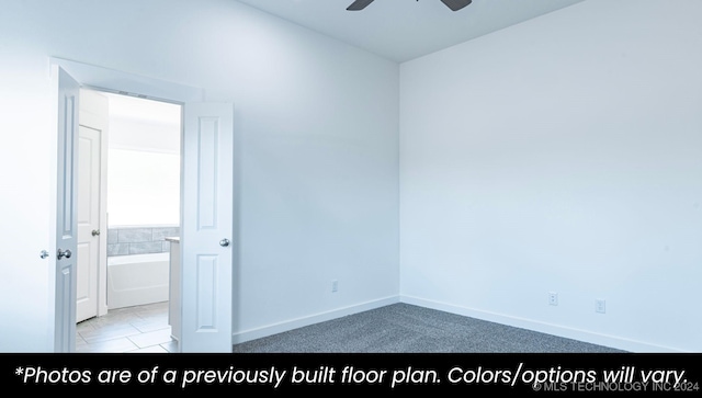 empty room with ceiling fan and light tile patterned floors