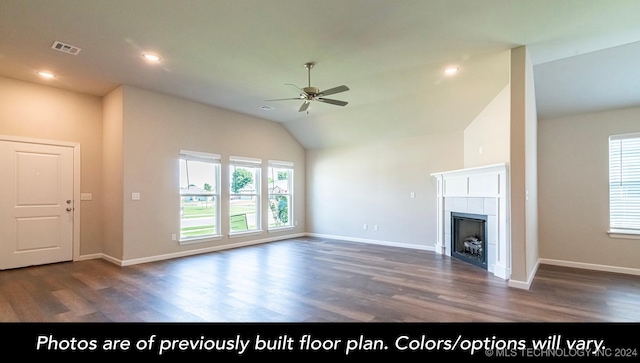 unfurnished living room with dark hardwood / wood-style floors, ceiling fan, a tile fireplace, and vaulted ceiling