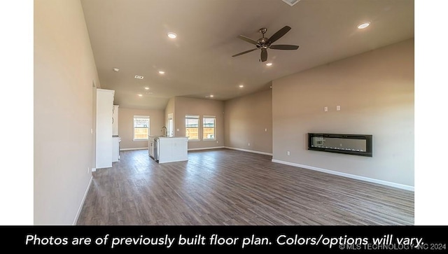 unfurnished living room featuring hardwood / wood-style floors, ceiling fan, and sink