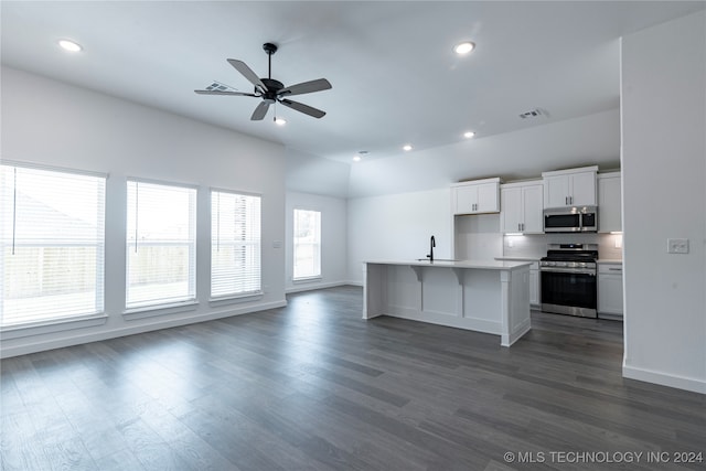 kitchen with a kitchen island with sink, plenty of natural light, white cabinets, and appliances with stainless steel finishes