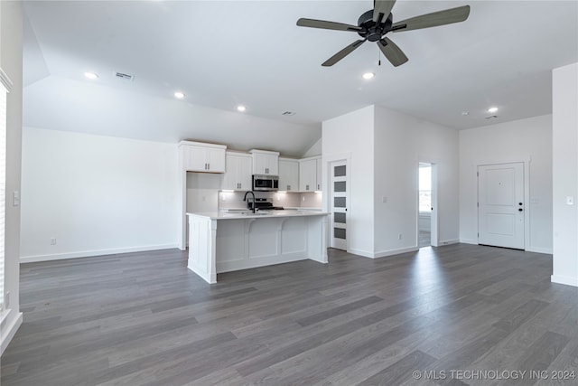 kitchen with white cabinets, dark hardwood / wood-style flooring, ceiling fan, and an island with sink