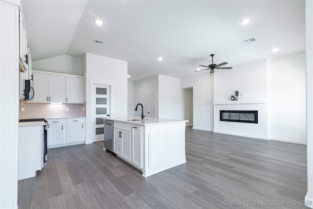 kitchen with white cabinetry, sink, dishwasher, tasteful backsplash, and a kitchen island with sink