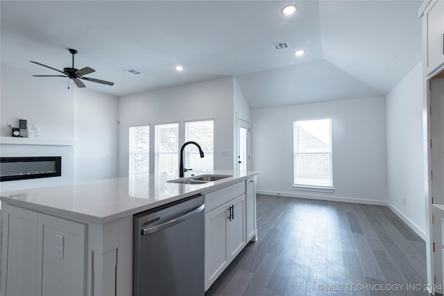 kitchen featuring light stone countertops, white cabinetry, stainless steel dishwasher, and sink