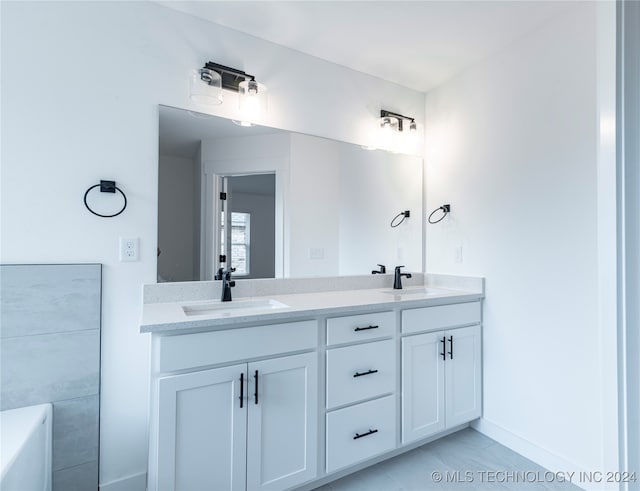 bathroom with tile patterned floors and vanity