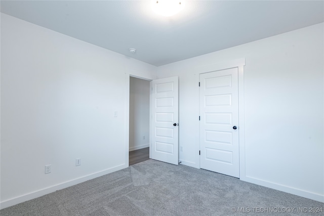 unfurnished bedroom featuring a closet and carpet