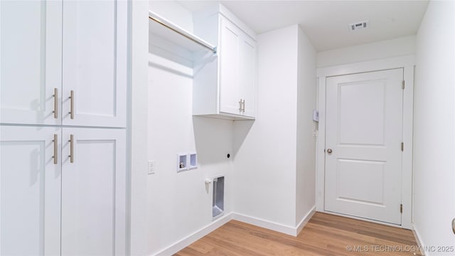 laundry room featuring electric dryer hookup, hookup for a washing machine, cabinets, and light hardwood / wood-style floors