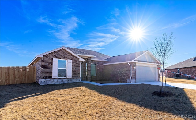 ranch-style house with a front yard and a garage