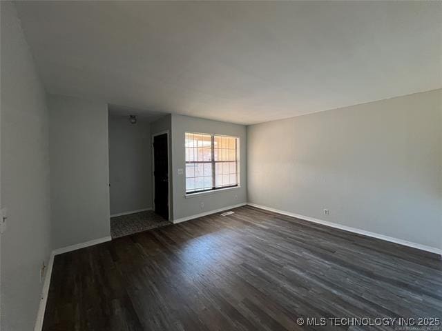 unfurnished room with dark hardwood / wood-style floors