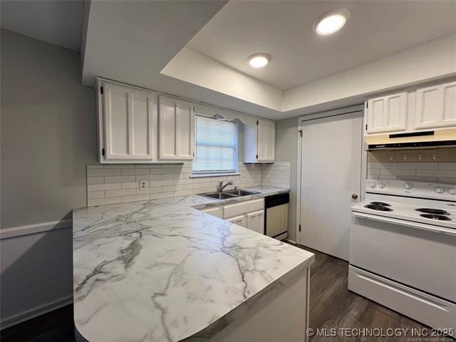 kitchen featuring white range with electric stovetop, a raised ceiling, and white cabinetry