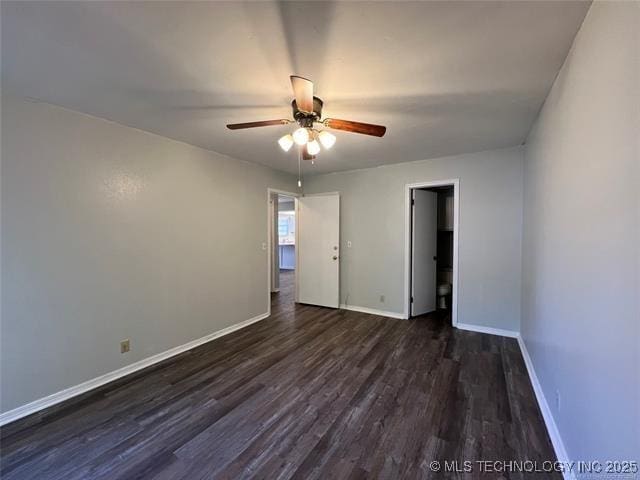 empty room featuring ceiling fan and dark hardwood / wood-style floors