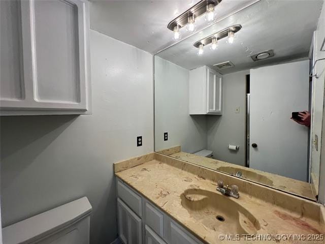 bathroom with vanity and toilet