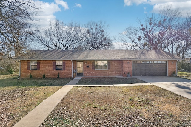 ranch-style house featuring a garage and a front lawn