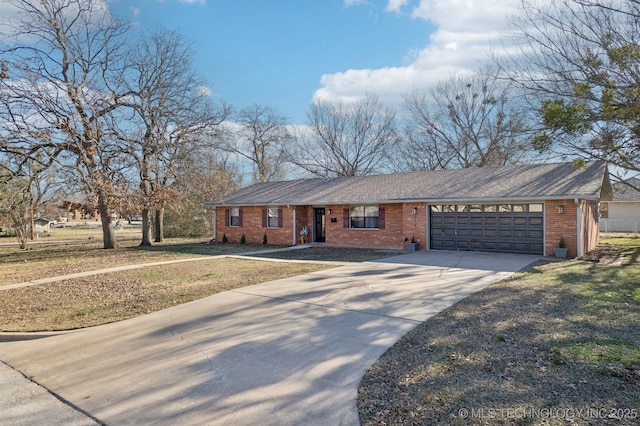 ranch-style house featuring a front yard and a garage