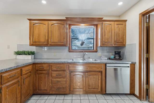 kitchen featuring sink, stainless steel dishwasher, tasteful backsplash, and light tile patterned floors