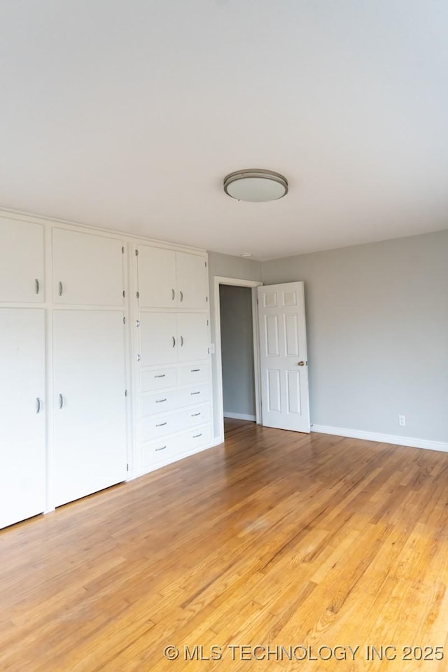 unfurnished bedroom with light wood-type flooring