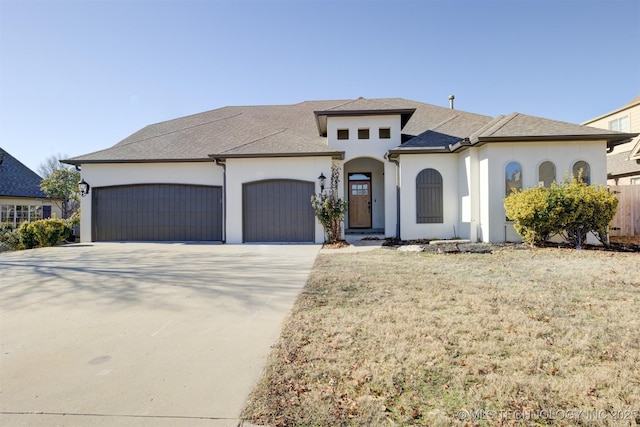 view of front of home with a garage and a front lawn