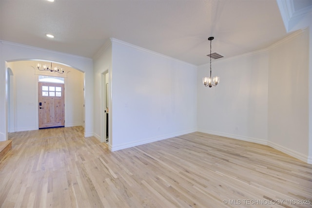 entrance foyer with crown molding, light hardwood / wood-style floors, and an inviting chandelier