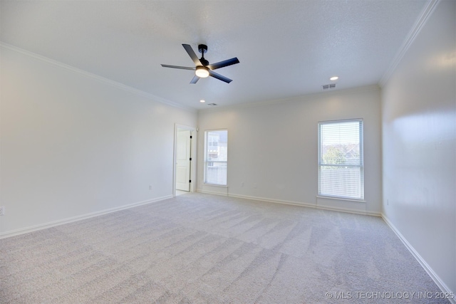 unfurnished room with a textured ceiling, ceiling fan, ornamental molding, and light carpet