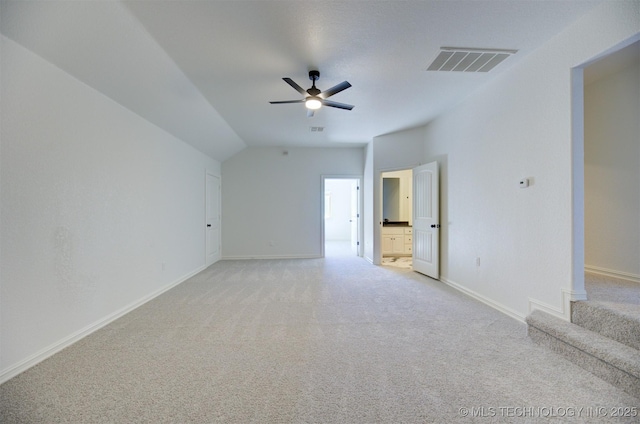 carpeted empty room with ceiling fan and lofted ceiling