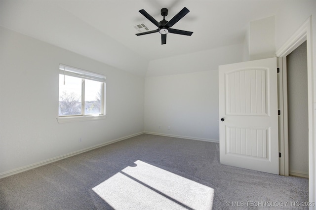 empty room featuring ceiling fan, lofted ceiling, and carpet floors