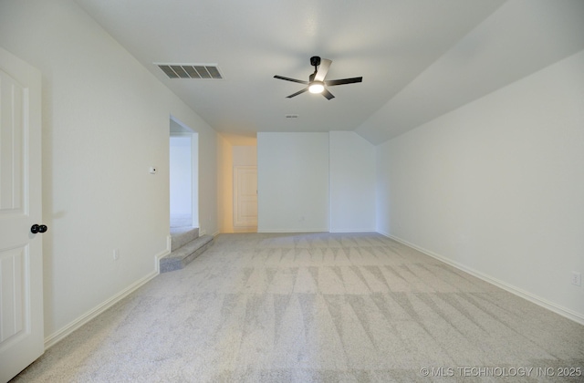 carpeted empty room with ceiling fan and lofted ceiling