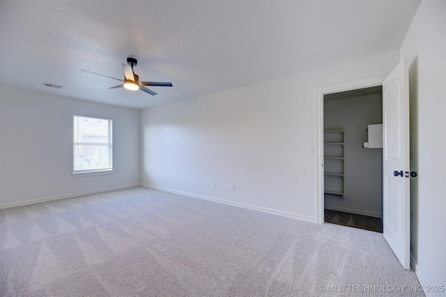 unfurnished room with ceiling fan and light colored carpet