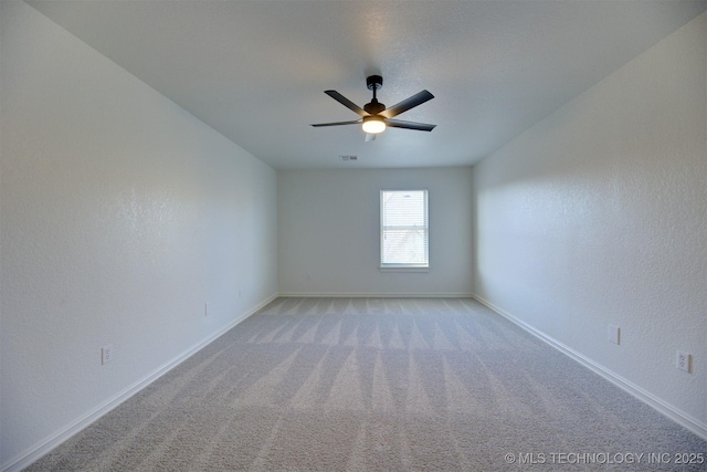 carpeted spare room with ceiling fan