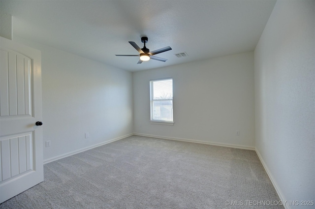 empty room with light colored carpet and ceiling fan