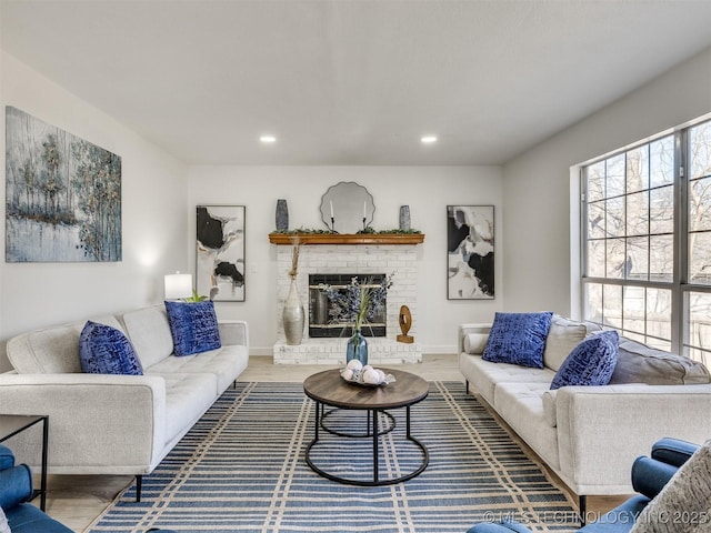 living room featuring hardwood / wood-style floors and a brick fireplace