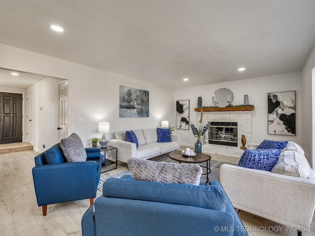 living room featuring light hardwood / wood-style floors and a fireplace