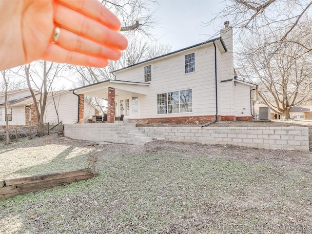 rear view of property with central air condition unit