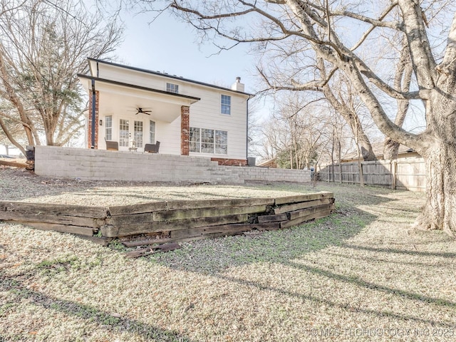 rear view of property featuring ceiling fan