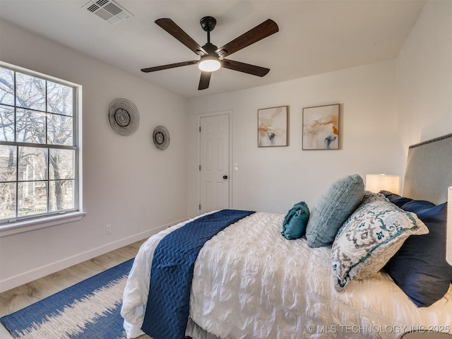 bedroom with hardwood / wood-style floors and ceiling fan