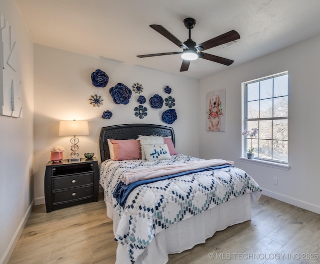 bedroom with ceiling fan and light hardwood / wood-style floors