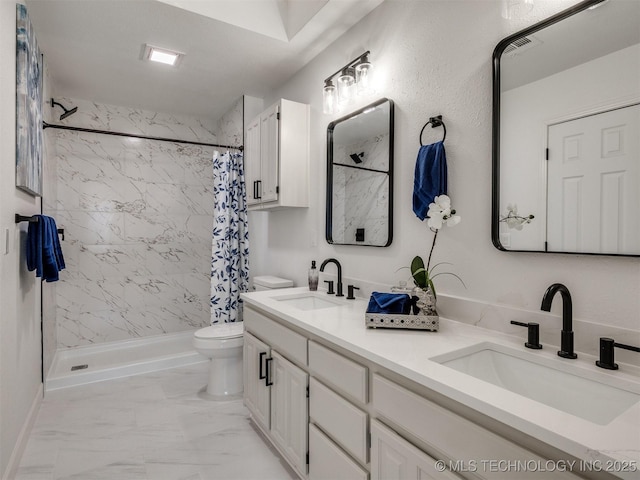 bathroom featuring toilet, vanity, and a shower with shower curtain