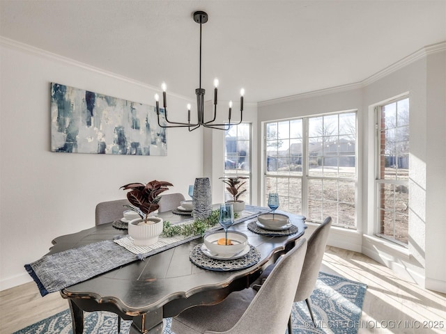 dining area featuring hardwood / wood-style flooring, ornamental molding, and an inviting chandelier