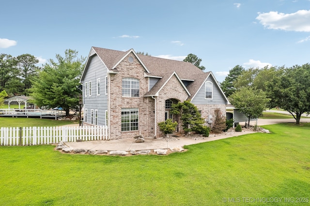 view of front of property with a patio area and a front yard