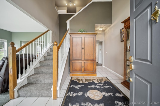 staircase featuring tile patterned floors