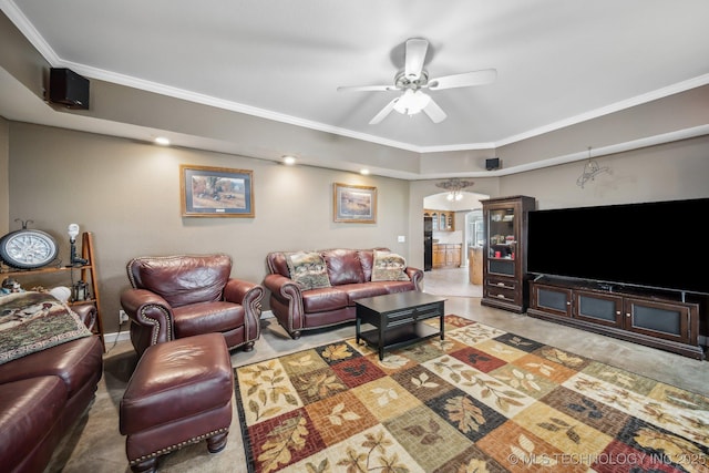 living room with ceiling fan and ornamental molding