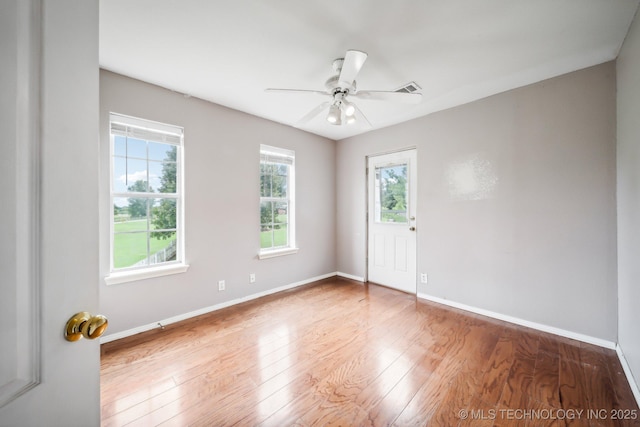 spare room with hardwood / wood-style floors and ceiling fan