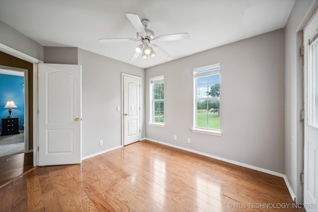 unfurnished bedroom featuring ceiling fan and light wood-type flooring