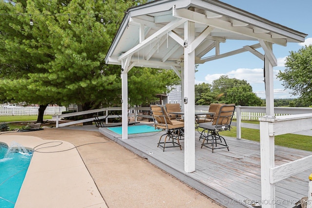 view of swimming pool featuring a wooden deck and pool water feature