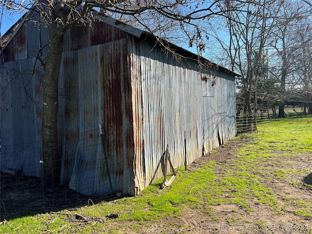 view of outdoor structure featuring a lawn