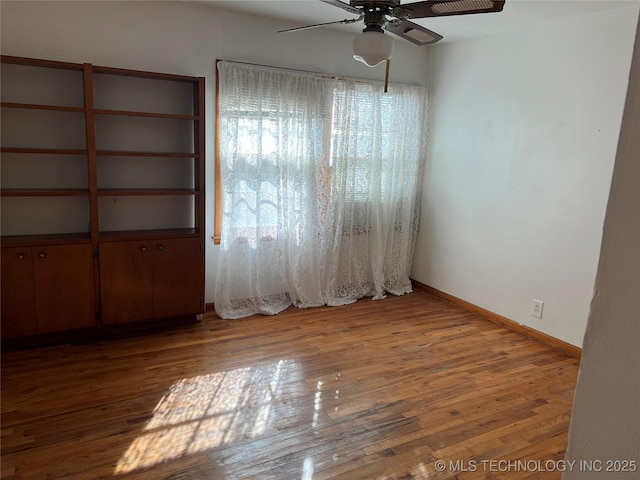 empty room with ceiling fan and light wood-type flooring