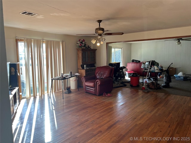 living room with ceiling fan and dark hardwood / wood-style flooring