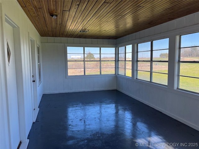 unfurnished sunroom with a healthy amount of sunlight and wood ceiling