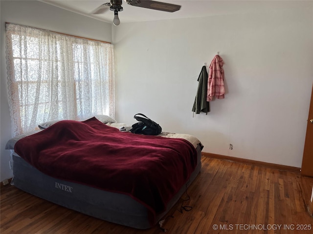 bedroom featuring dark hardwood / wood-style flooring and ceiling fan