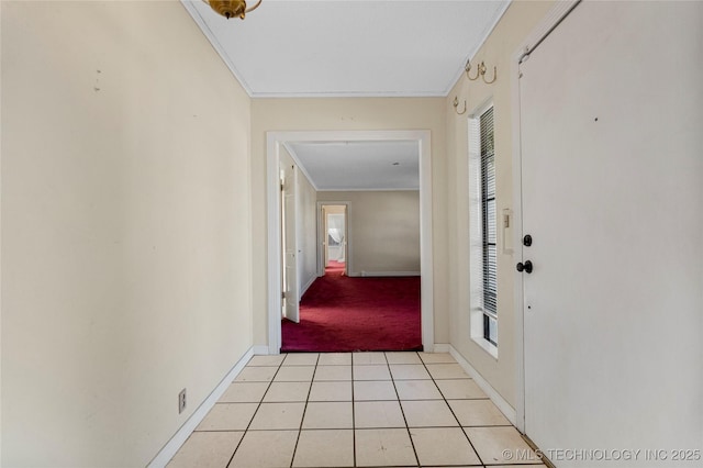 hallway featuring light tile patterned flooring, a healthy amount of sunlight, and ornamental molding